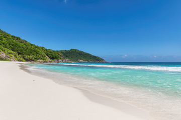 Sandy beach with turquoise sea. Tropical beach background.
