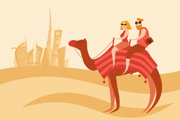 Tourists couple camel riders in the desert near Dubai city
