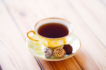 Vintage cup of tea with natural sweets and jar of honey on the wooden background. Sunny morning.  