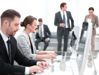 employees use computers to work with clients