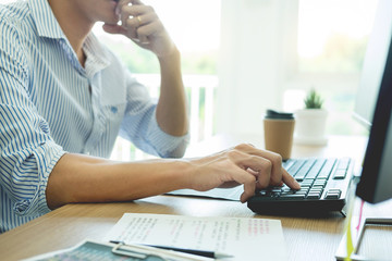 Serious busy hipster young web software developer programmer is coding or programming on a desktop...