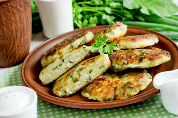 Cottage cheese pancakes or syrniki with herbs green onion and parsley
