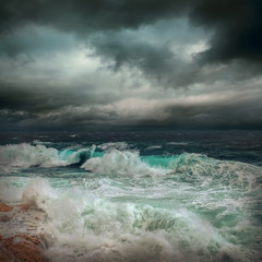 Stormy sea view  near coastline at evening time. Waves, splashed