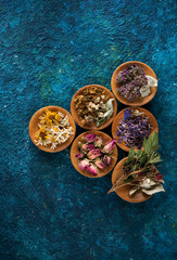 Various medical herbs and flowers in bowls