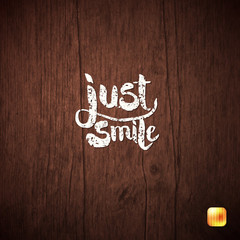 White Simple Text concept Just Smile on Wood.
