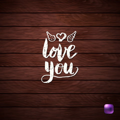 White Love You Text on Wooden Textured Background.