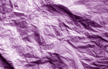 Fototapeta premium Crumpled sheet of paper in purple color.