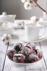 Red velvet cookies on a white table, white cups and mint