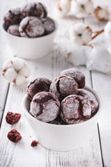 Red velvet cookies on a white table, white cups