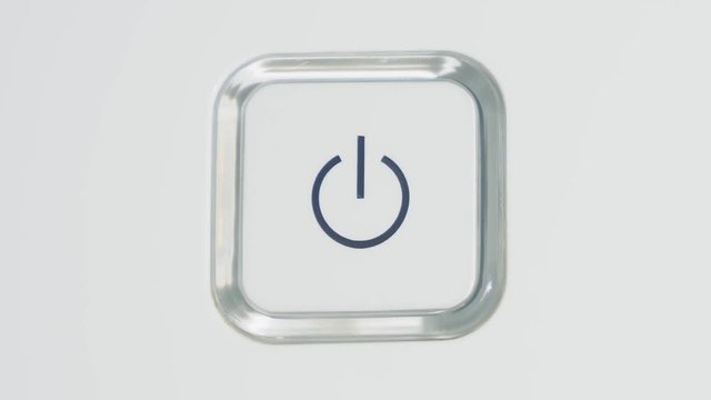 Someone press the power button. Turning on a power button on white background