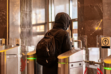 rear portrait of person go through security turnstile b