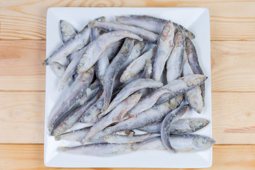 Frozen baltic herring on a square white dish