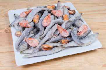 Frozen various seafoods on a square white dish