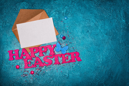 Pink Text Of Happy Easter And Mock-up Letter With White Gretting Card In Kraft Envelope