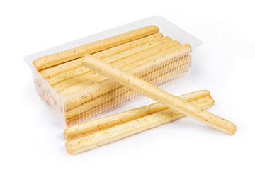 Breadsticks with sesame seeds on a white background