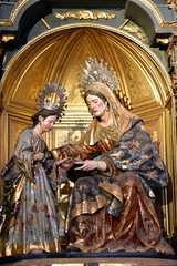 A sculpture of Saint Anne teaching the Virgin Mary is displayed in the Divino Salvador Church in Seville, Andalusia, Spain © akturer
