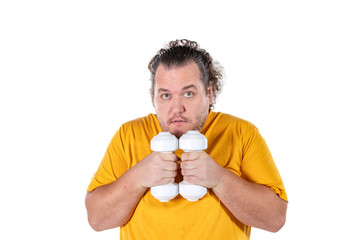 Funny fat man exercising with dumbbells and looking at camera isolated on white background