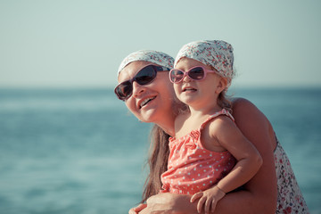 Portrait of happy mother and daughter at sea