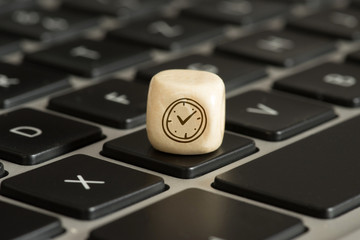 Ein Computer und ein Würfel mit einer Uhr