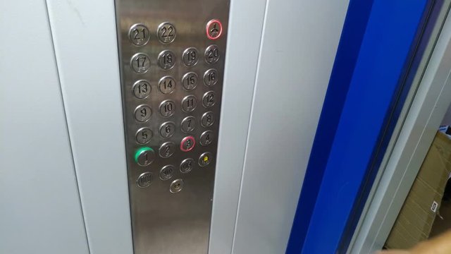 The girl presses the elevator button