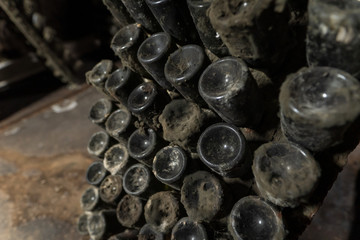 Wine aging bottles covered in dust and mold