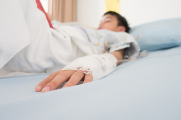Little boy get sick from influenza need to be admitted to hospital with saline intravenous (iv) ...