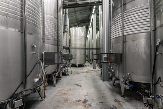Modern winery interior with aluminium tanks with controlled cooling system