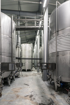 Inside of a modern winery with controlled temperature wine tanks