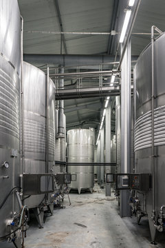 Inside of a modern winery with controlled temperature wine barrels