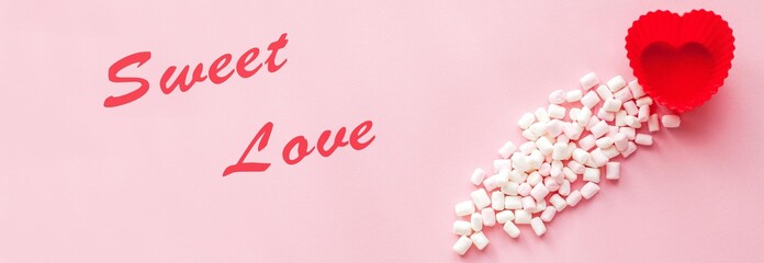 Red heart shape with marshmallows on pink background. Valentine's Day. Love. Holiday.