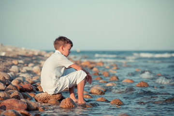 Portrait of teenager sitting near sea, outdoor