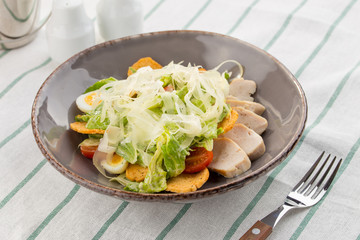 Healthy Grilled Chicken Caesar Salad with parmesan Cheese and Croutons served on the table