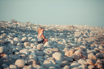 Adorable girl walking along beach