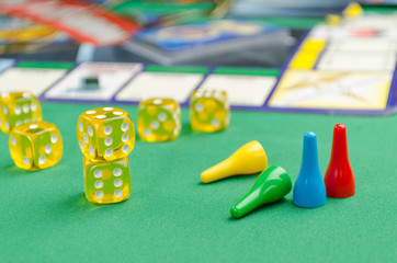 yellow game dice for board game on a green background