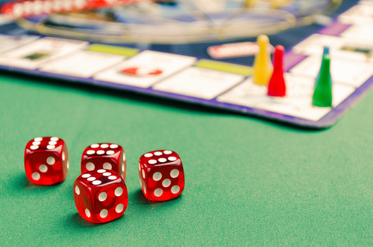 several red dice for board games on a green background