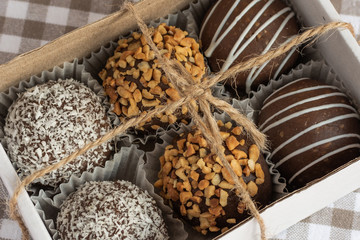 Different muffins in a gift box top view. Sweet chocolate cakes. Copy space. 