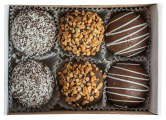 Different muffins in a gift box top view. Sweet chocolate cakes. Copy space. 