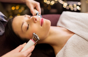 people, beauty, cosmetology and technology concept - beautiful young woman having needle free...