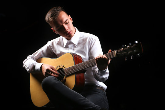 Young men playing the guitar