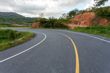 Asphalt road curve on the mountain in bad weather day