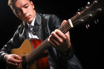 Young men playing the guitar