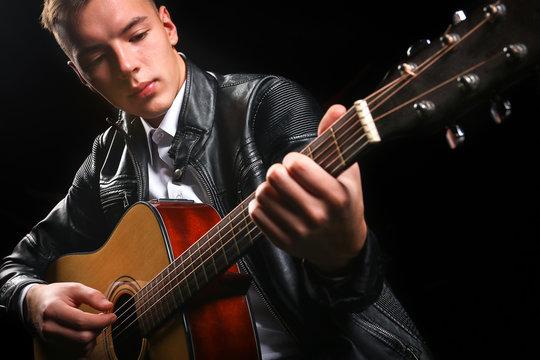 Young men playing the guitar