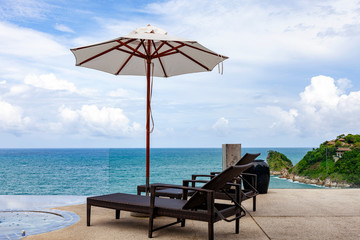 Beach chair in outdoor with swimming pool and sea view andaman sea