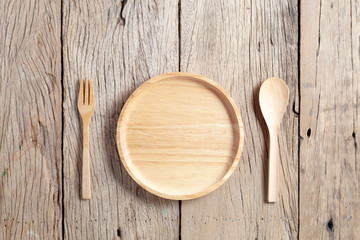 wooden spoon and wooden plate on old wood table background,copy space for your product and cooking design