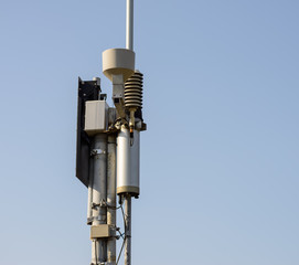 Automatic weather station on blue sky background.