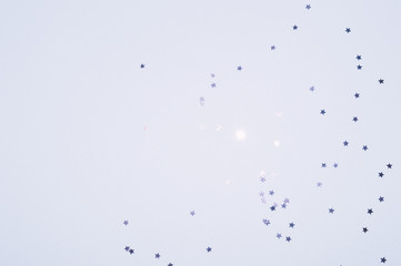 Silver glitter stars on blue background in vintage colors