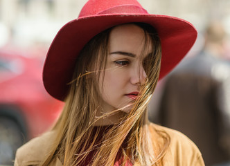 Woman in vintage cloak and red hat.