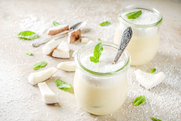 Obraz na płótnie Canvas Vegan coconut panna cotta dessert in glass jar