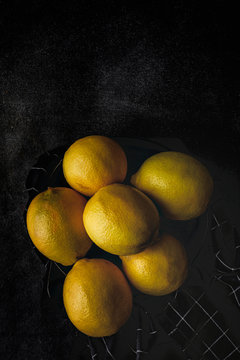 Fresh lemons on dark background.