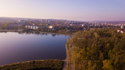Fototapeta na wymiar Aerial view of the autumn city park near the lake.